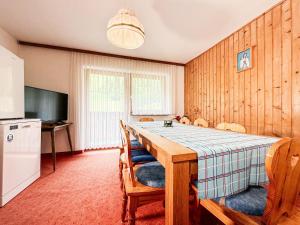 a kitchen and dining room with a table and chairs at Haus Schönblick in Bschlabs