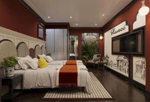 a bedroom with a large bed and a flat screen tv at The 39 Lane Hotel Hanoi in Hanoi