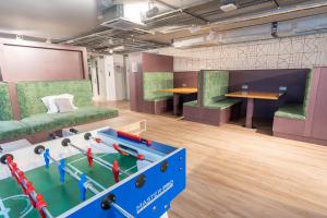 a room with a ping pong table in the middle at City HideAway in Galway