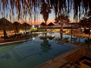 a swimming pool with chairs and umbrellas in a resort at Blue Bay Club in Vrachonisída Omprélla