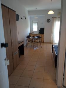 a kitchen and dining room with a table and chairs at Blue Bay Club in Vrachonisída Omprélla