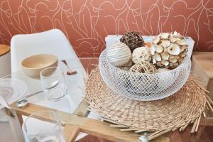 a table with a white bowl on top of a table at Le Corail - centre-ville - TV in Pontivy
