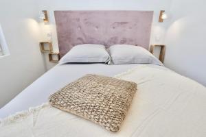 a white bed with a pillow on top of it at Le Corail - centre-ville - TV in Pontivy +1 photo