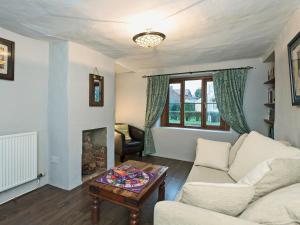 a living room with a couch and a fireplace at Horseshoe House - Ukc2743 in Watton