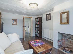 a living room with a couch and a fireplace at Horseshoe House - Ukc2743 in Watton