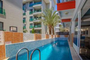 a swimming pool in front of a building at Dublin Hotel in Alanya
