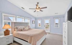 a bedroom with a bed and a ceiling fan at Mischief Managed NC in Oak Island +18 photos