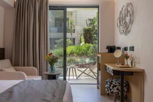 a bedroom with a bed and a living room at Pearl Beach in Rethymno