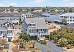 an aerial view of a large house with a body of water at Mischief Managed NC in Oak Island