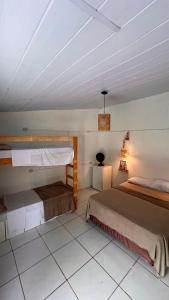 a bedroom with two beds and a ceiling at Casa Folha Tropical in Pipa +37 photos