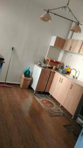 a kitchen with wooden cabinets and a wooden floor at Jijel in Jijel