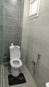 a bathroom with a toilet and a window and a shower at Jijel in Jijel