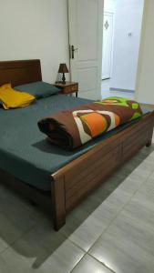 a bed with a wooden frame in a bedroom at Jijel in Jijel