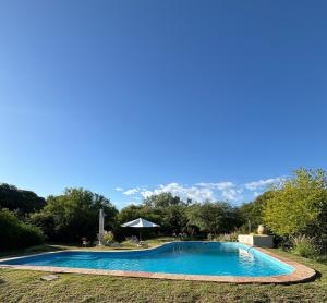 a blue swimming pool with mountains in the background at Varuna- en La Casa de Nanda in San Javier