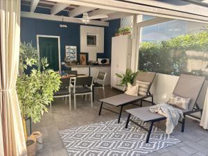 a patio with chairs and a table and a kitchen at FIORDO 448 in Isola Albarella