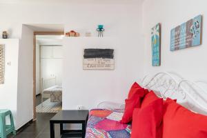 a room with a bed with red pillows on it at Με συμπάθεια-With sympathy - private parking in Kavála