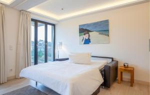 a bedroom with a bed and a painting on the wall at Eden in Binz
