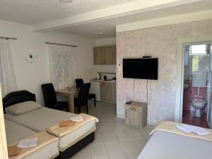 a living room with two beds and a kitchen at Apartmani Čavor in Budva