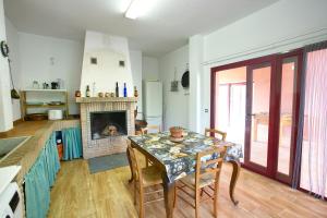 a dining room with a table and a fireplace at Cuencaloft Villa Los Perales in Villalba de la Sierra