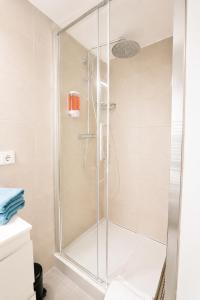 a shower with a glass door in a bathroom at Core Luxembourg City in Luxembourg