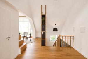 a staircase in a house with white walls and wooden floors at Core Luxembourg City in Luxembourg +19 photos