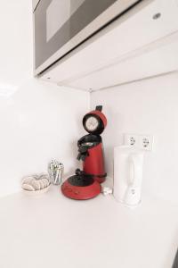 a kitchen counter with a clock and other kitchen items at Core Luxembourg City in Luxembourg
