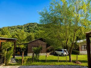 a house with a car parked in a yard at Complejo La Cascada San Javier in San Javier