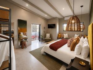 a bedroom with a bed and a living room at Belle Maroc Boutique Hotel in Bloubergstrand
