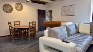 a living room with a couch and a table at Les Vieilles Planches in Pampelonne