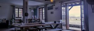 a living room with a wooden table and a window at Mas Lartigues in Taurinya