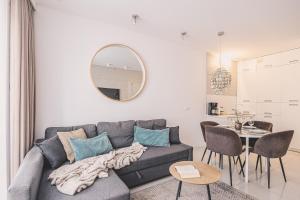 a living room with a couch and a table at Maritimo Apartament przy Porcie by 2HomeRent in Kołobrzeg