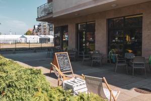 a restaurant with a sign in front of a building at Maritimo Apartament przy Porcie by 2HomeRent in Kołobrzeg