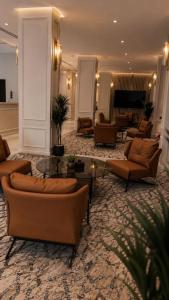 a living room with couches and tables in a lobby at اجنحة الفخامة للشقق الفندقية in Taif