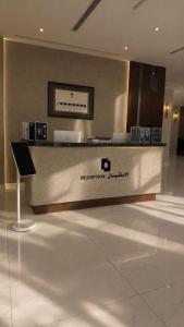 a reception desk in a building with a sign on it at اجنحة الفخامة للشقق الفندقية in Taif