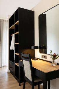 a dining room with a desk and a closet at Kleine Banhoek Manor in Stellenbosch