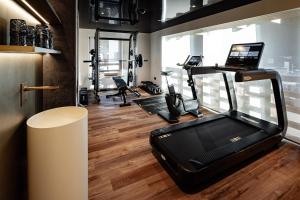 a gym with a treadmill and elliptical machines at Boutique Hotel Nives - Luxury & Design in the Dolomites in Selva di Val Gardena