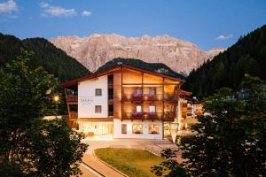 a large building in the middle of a mountain at Boutique Hotel Nives - Luxury & Design in the Dolomites in Selva di Val Gardena