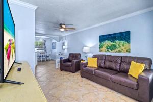 a living room with a couch and two chairs at Barefoot Beach Resort F104 in Clearwater Beach
