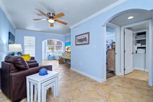 a living room with a couch and a ceiling fan at Barefoot Beach Resort F104 in Clearwater Beach