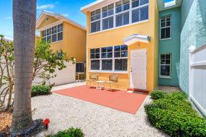 a house with a table and chairs in front of it at Barefoot Beach Resort F104 in Clearwater Beach