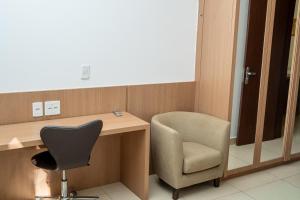 a desk and a chair in a room at The Sun Full Condominiun in Brasília +38 photos