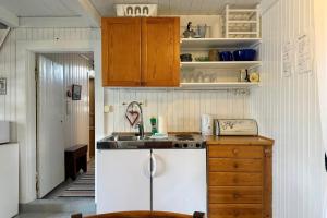 a small kitchen with a sink and a counter at The traditional Burekka 17 - Lofoten in Stamsund +28 photos