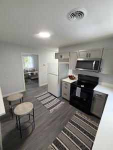 a kitchen with white cabinets and a stove top oven at Crewe Corner D in Crewe