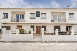 a white building with windows and balconies at Raízes 22 - Apartamento 4 in Puebla de Don Fadrique
