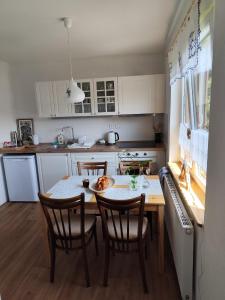 a kitchen with a table with a plate of food on it at Chalupa Meduňka in Vsetín