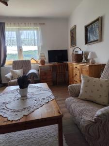 a living room with a couch and a table at Chalupa Meduňka in Vsetín