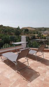 two chairs sitting on top of a roof at Casa Benzambra in Cádiar