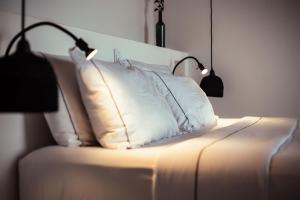 a bed with two pillows and two lamps on it at Kibuye House in Kibuye