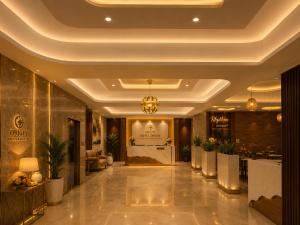 a lobby of a hotel with a reception desk at Hotel ORIGIN Hyderabad Airport in Hyderabad