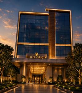 a hotel office building with a sign that reads hotel origin at Hotel ORIGIN Hyderabad Airport in Hyderabad